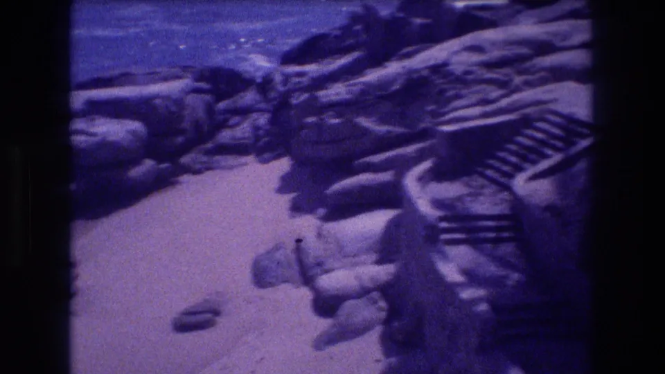 Boulders and a stepped stone or concrete structure at the shoreline with ocean visible at upper left, 8mm home movie, Acapulco, Mexico, 1982.