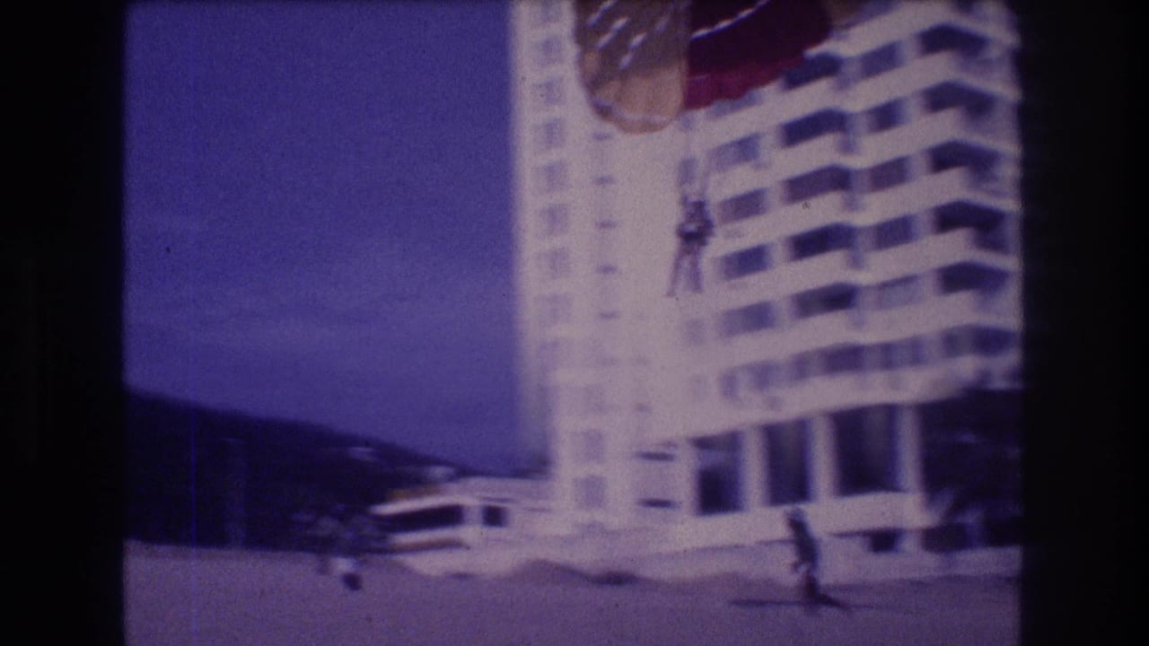 Super 8 home movie, c.1982 Acapulco: parasailor approaching beach landing with a running figure in the foreground, resort hotel behind