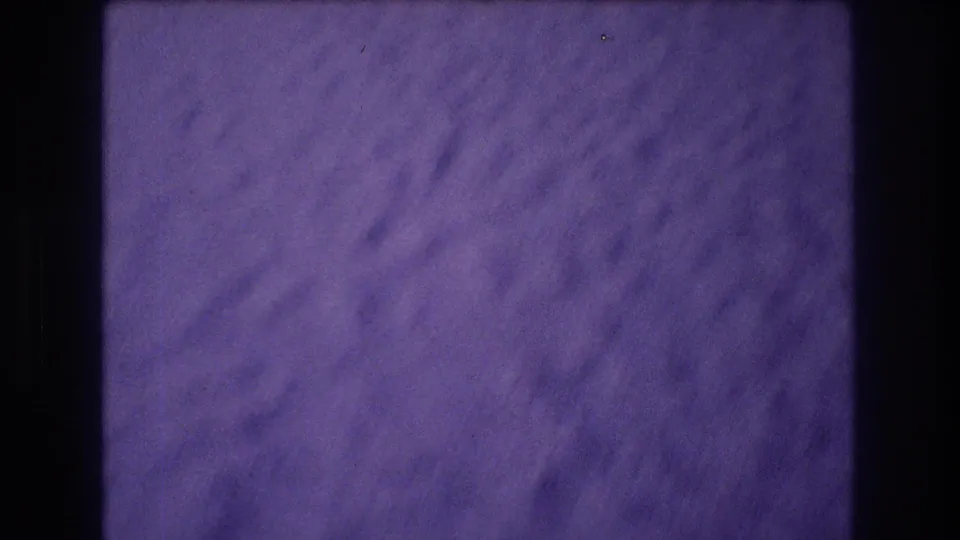 Close view of rough stucco wall with purple 8mm color shift at the end of the pan sequence, Acapulco Mexico circa 1982.