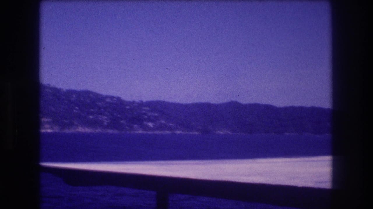 Boat edge in front of distant hills across the water.