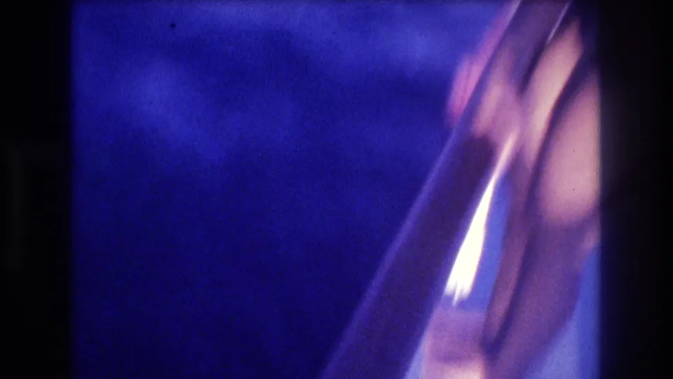Blurred transitional frame of deep blue water and a white boat hull or railing, 8mm home movie, possibly panning away from subject toward ocean, Acapulco, circa 1982.