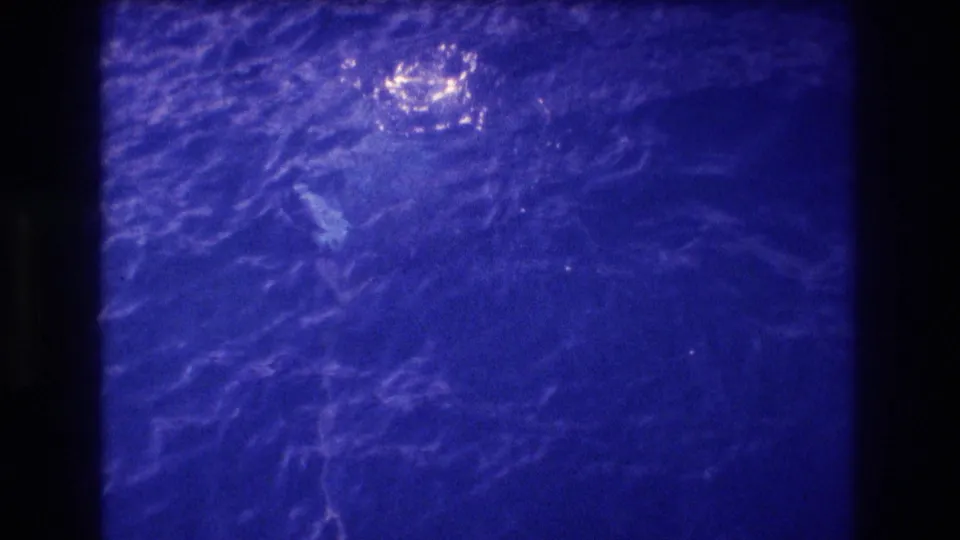 Super 8 home-movie view of deep blue ocean surface with glare reflection, likely Pacific waters off Acapulco, Mexico, circa 1982.