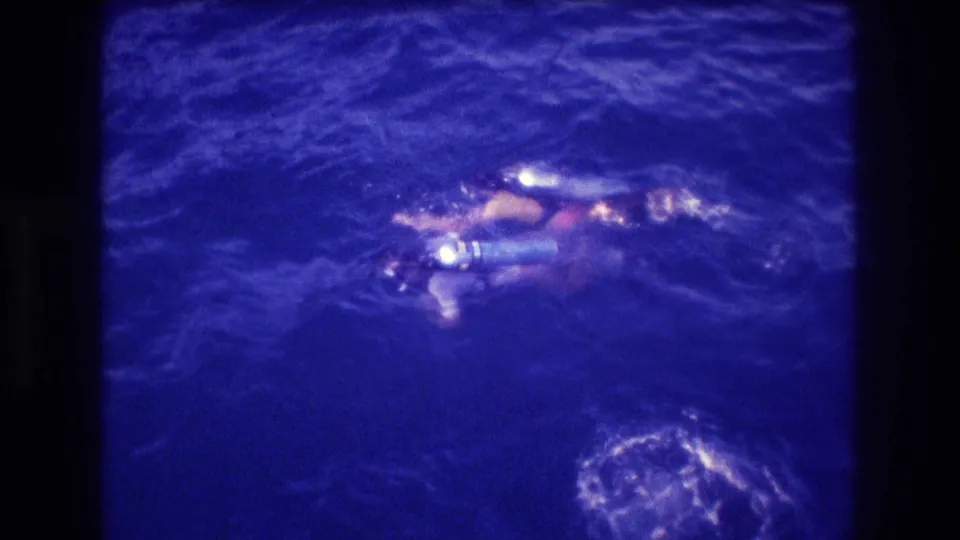 Two swimmers with snorkeling gear at the ocean surface filmed from above, consistent with home-movie footage from Acapulco, Mexico, circa 1982.
