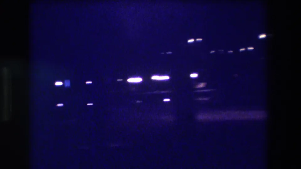 Multiple overhead lights clustered in upper frame on underexposed 8mm film at night, Acapulco, Mexico, ca. 1982.