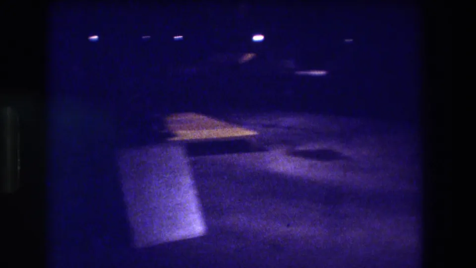 8mm night footage from Acapulco, Mexico, 1982, showing a row of overhead lights and a warm-lit angled surface or low structure in the lower frame.