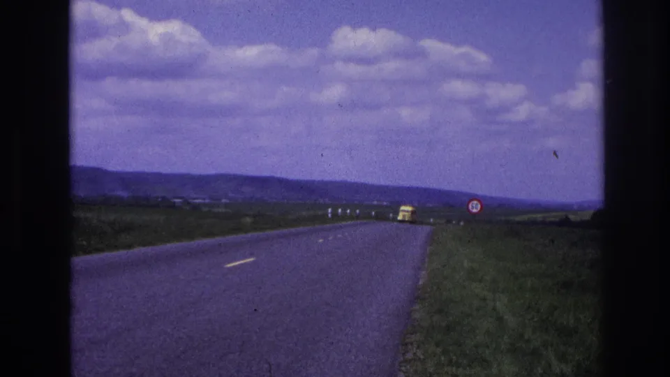 In the final frame, a yellow car is closer on the rural French road, passing near the 50 speed limit sign with fields and low hills in the background.