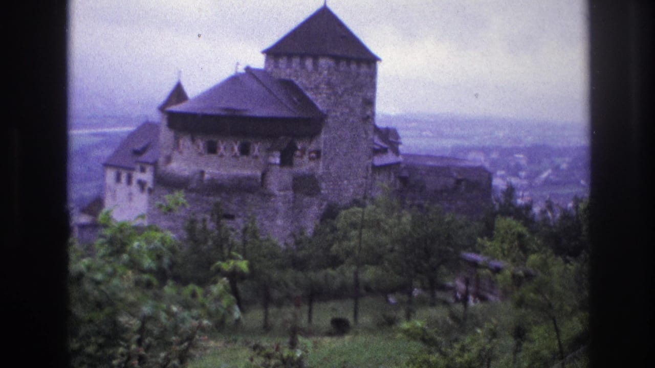 Medieval stone castle in France, circa 1967, 8mm home movie showing two towers and stone walls with hazy valley visible in background.
