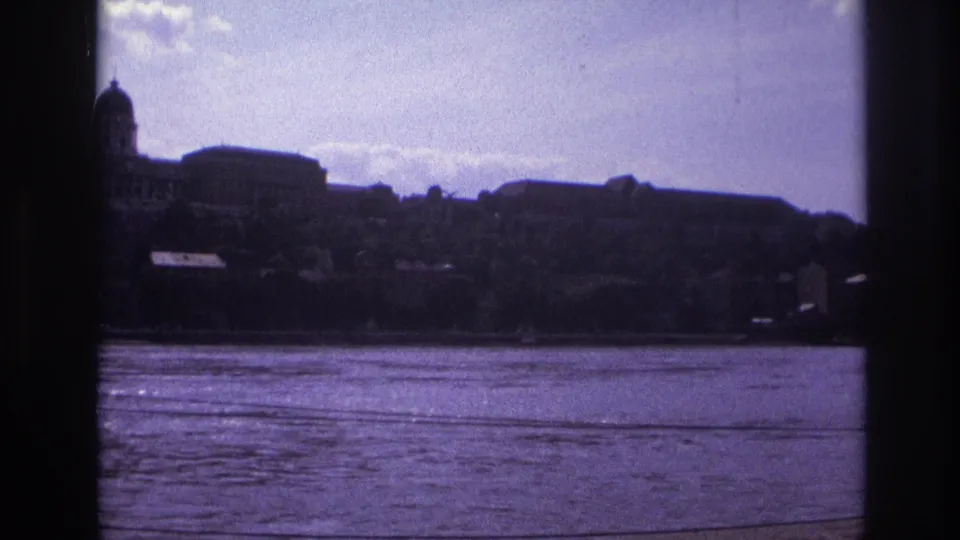 1967 France river scene with dark window-like edges, a dome at the left, and clustered buildings along the far bank.
