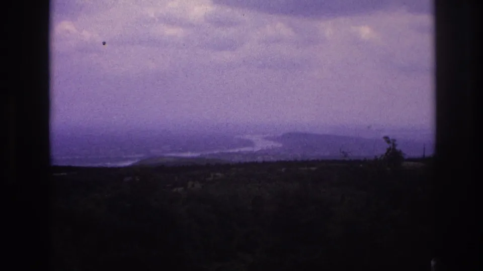 1967 France 8mm view of a broad river bend fading into atmospheric haze above dense trees.