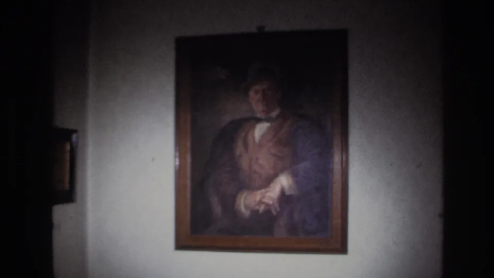 1967 France 8mm frame with the portrait centered on a pale wall as dark edges and soft exposure frame the shot.