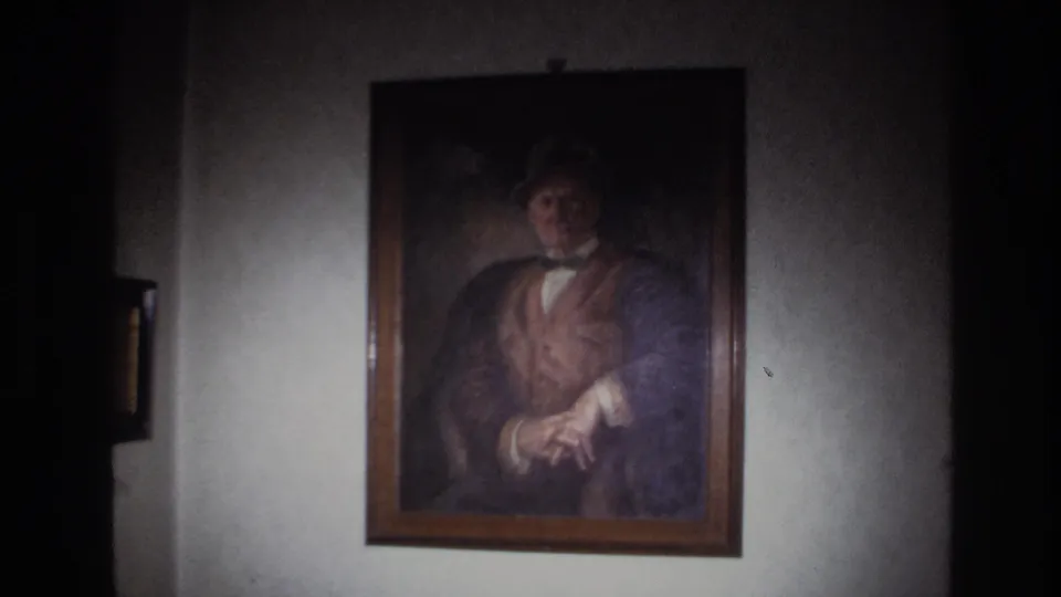 1967 France 8mm frame showing a framed portrait on a wall inside a dim private interior.