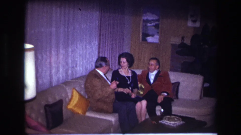 The final 1967 Ottawa frame shows the trio on the sofa as the woman turns toward the man in brown beside her.
