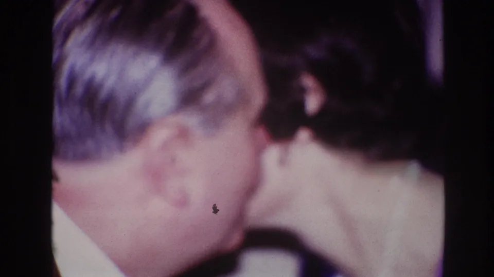 A suited man embraces the woman on stage, closing the Ottawa award moment with a congratulatory gesture.