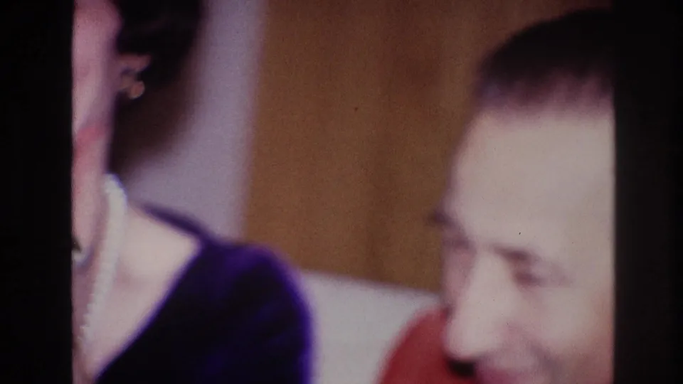 Soft 1967 Ottawa home-movie frame showing the man in a red shirt near the cropped woman after the kiss.