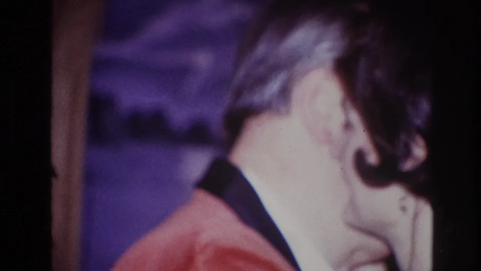 The couple remains in a close dance embrace, with the woman's head near the man's shoulder in soft 1967 Ottawa home-movie footage.