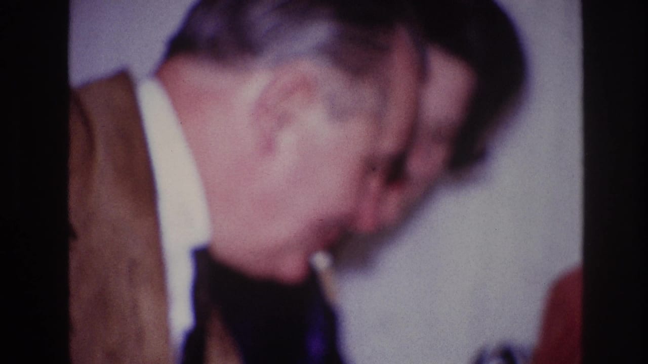 In the supported 1967 Ottawa clip, a man wearing glasses and a brown suit jacket passes through the close handheld frame.