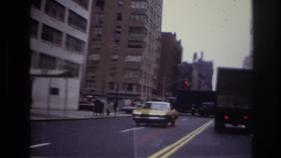 1967 Ottawa street view with mid-century cars, pedestrians, apartment buildings, and a yellow taxi in traffic.