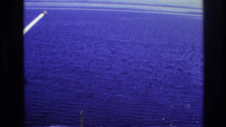 1967 Ottawa ferry-crossing view where rippled blue water dominates the frame, with a small section of ferry edge at left.