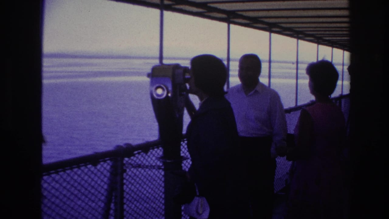 1967 Ottawa home-movie frame showing adults in silhouette near a tower viewer on a covered boat deck facing bright water.
