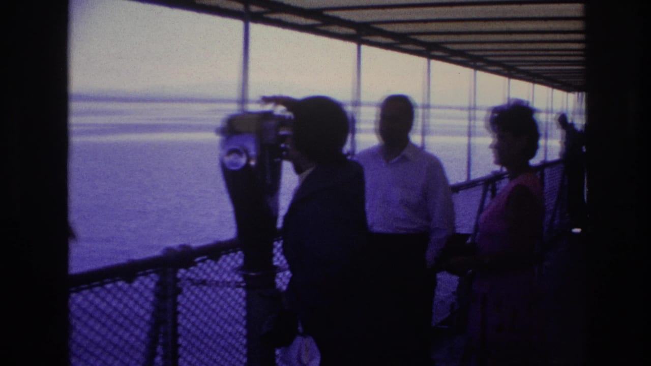 1967 Ottawa footage frame with a woman at a coin-operated viewer, two adults nearby, and open water beyond the deck railing.