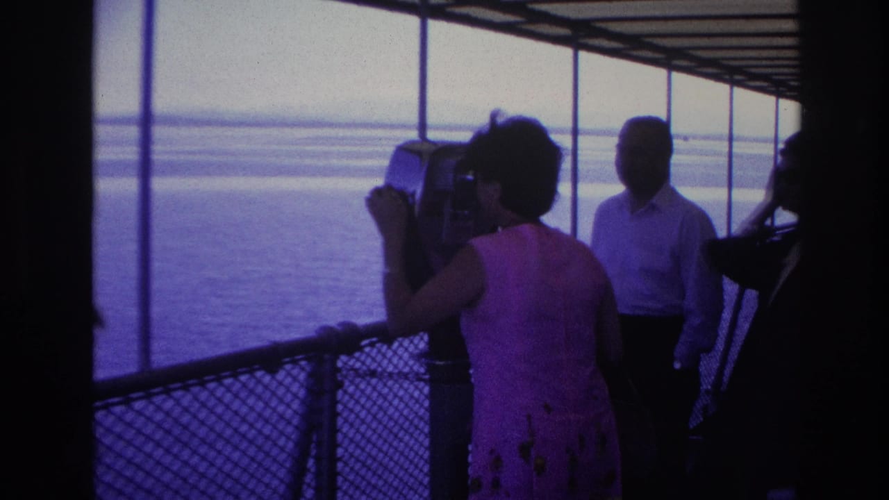 On the Ottawa boat tour, the woman faces the mounted viewer as other adult tourists stand in shadow near the water-facing deck.