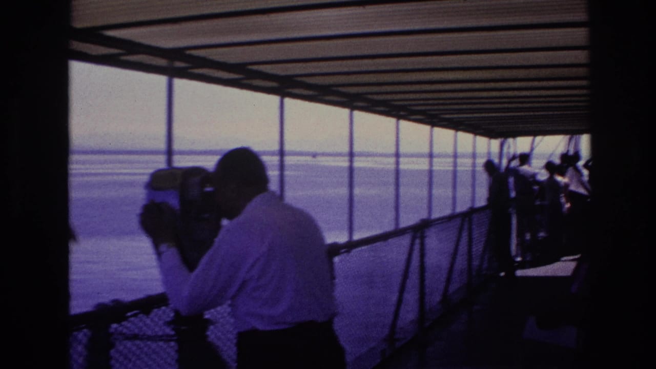 1967 Ottawa boat-deck footage shows a silhouetted man using a coin binocular viewer while passengers stand near the railing.
