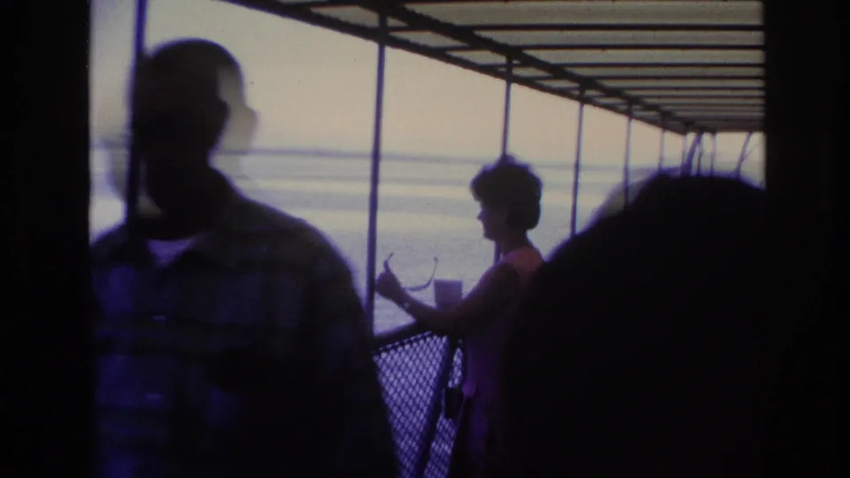 1967 Ottawa home-movie frame with a foreground passenger crossing the lens and a woman by the boat railing.