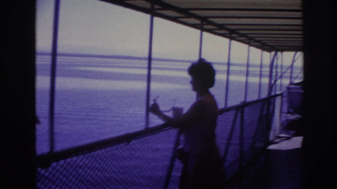 Silhouetted woman standing by a ship railing with open water beyond.