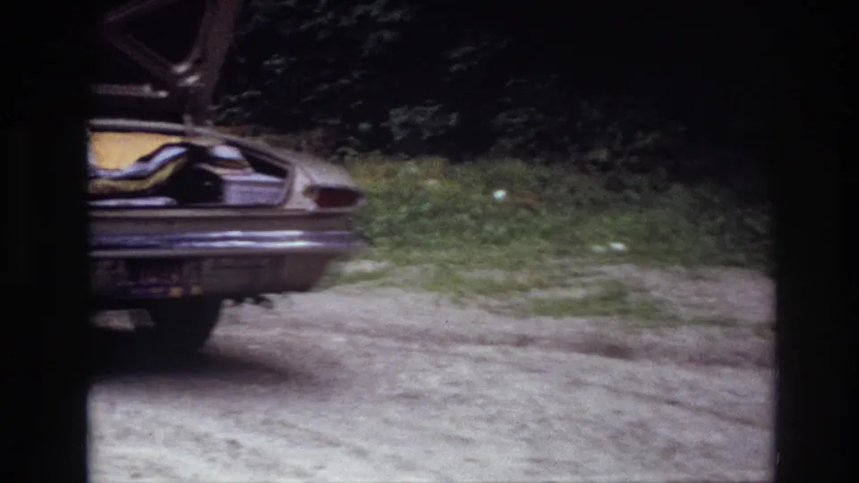 Final frame shows a partial rear view of the 1967 Ottawa roadside sedan, with open trunk, packed items, trees, and dirt ground.