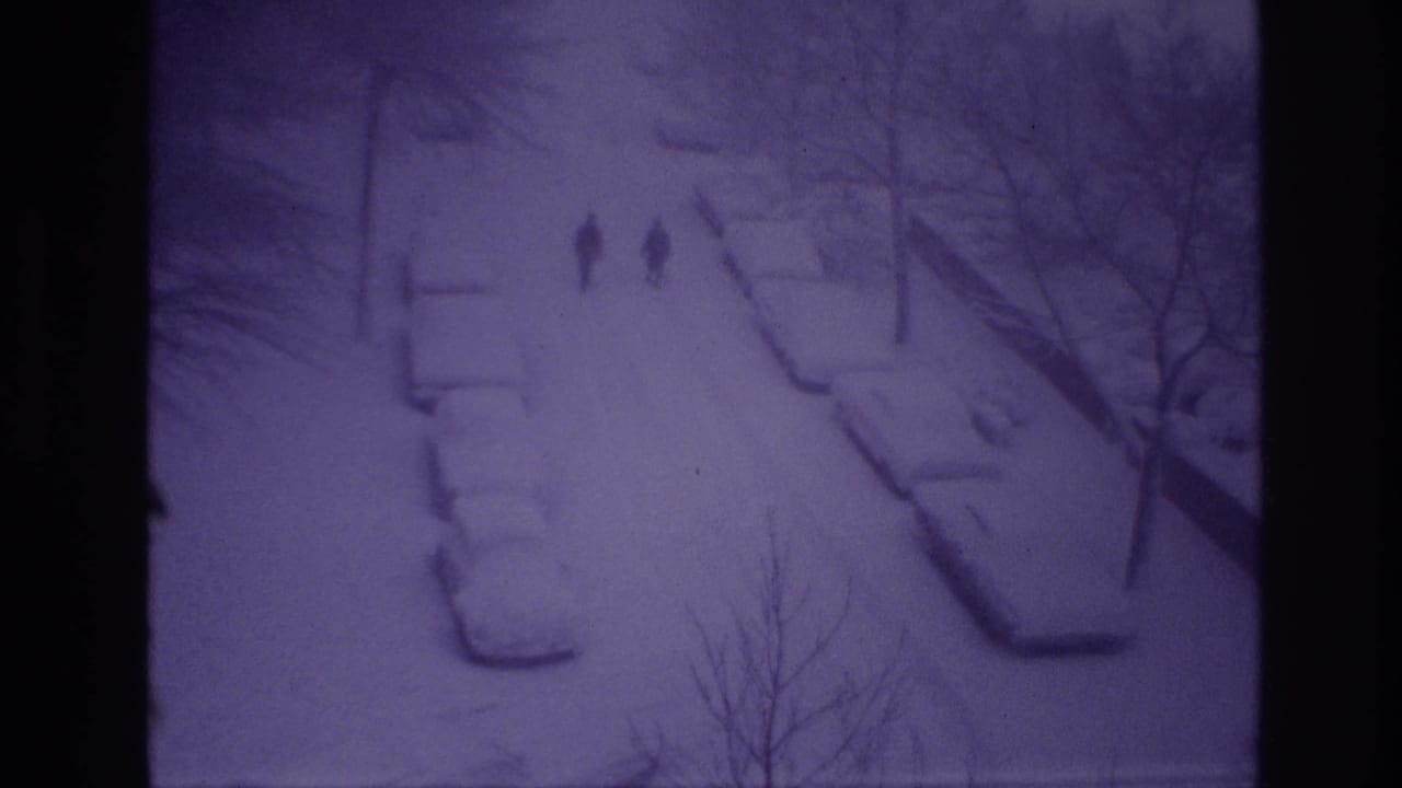 Final frame of a 1967 Ottawa winter street scene with two silhouetted walkers and snow-covered cars.