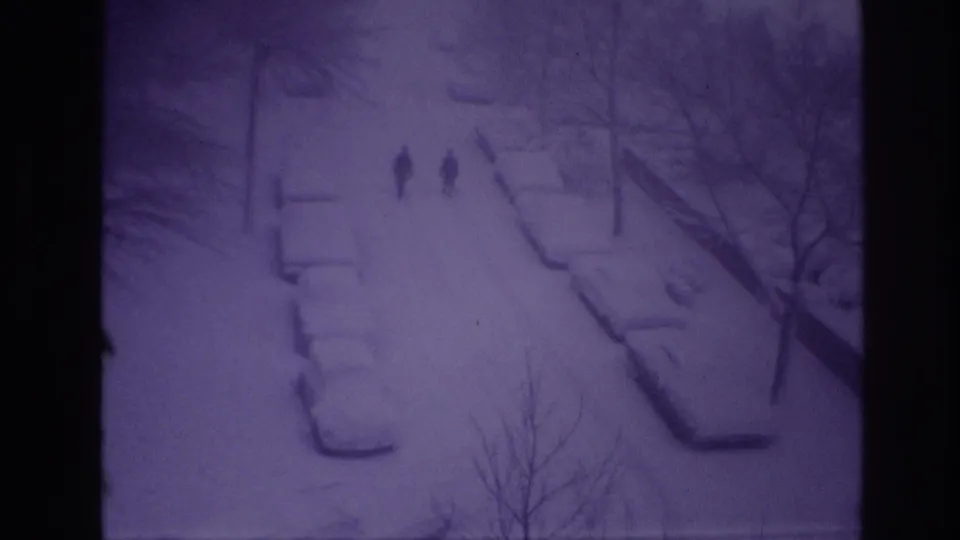 Final frame of a 1967 Ottawa winter street scene with two silhouetted walkers and snow-covered cars.