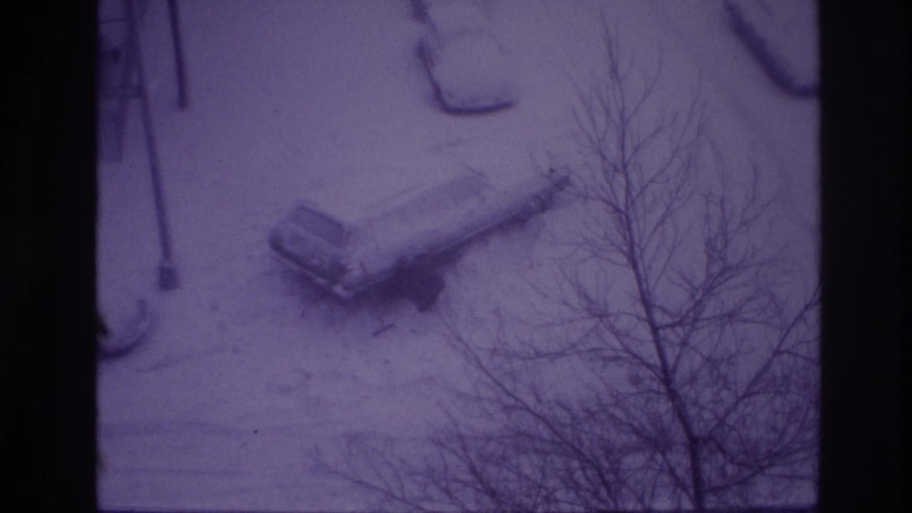 1967 Ottawa winter street frame with a snow-covered parked car, streetlamp, and bare trees in a purple-tinted 8mm view.