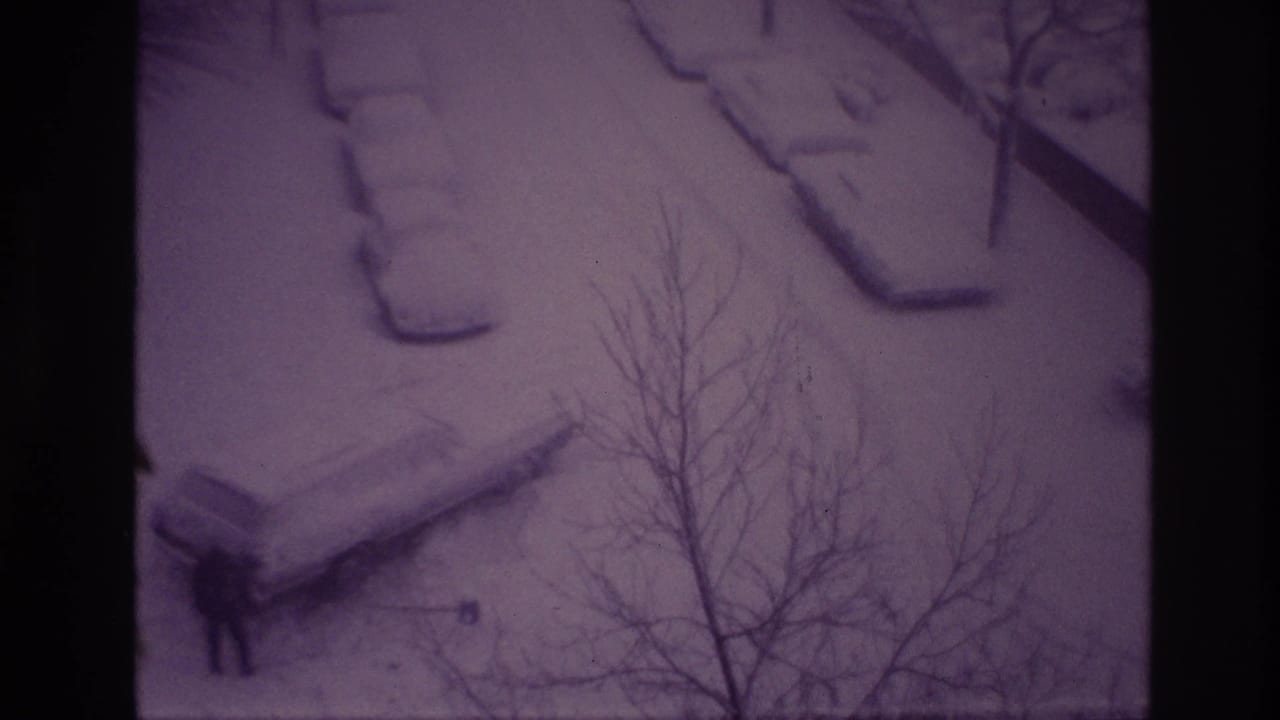 Elevated 1967 Ottawa winter frame showing a distant man in dark clothing beside a snow-covered parked car.