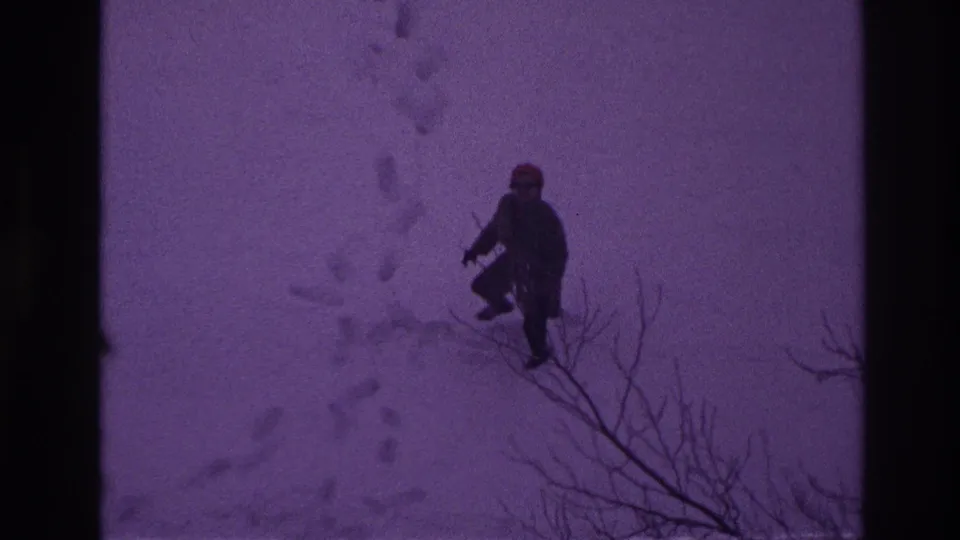 A bundled figure appears farther from the camera in deep snow, leaving footprints across the Ottawa winter scene.
