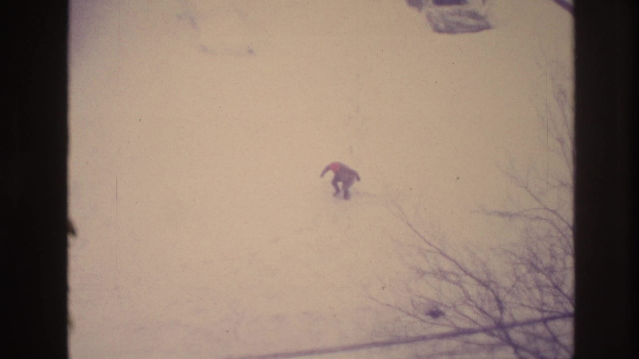 In the final faded frame, the man bends or crouches in the Ottawa snow, with bare branches visible at the lower right.