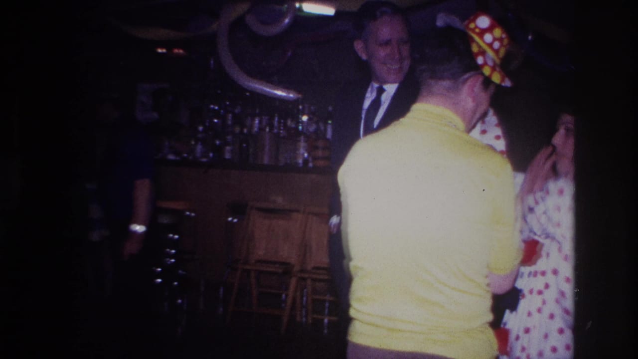 1967 Ottawa party scene with a man in a yellow shirt, a woman in a polka-dot dress, and a suited onlooker beside a decorated bar.
