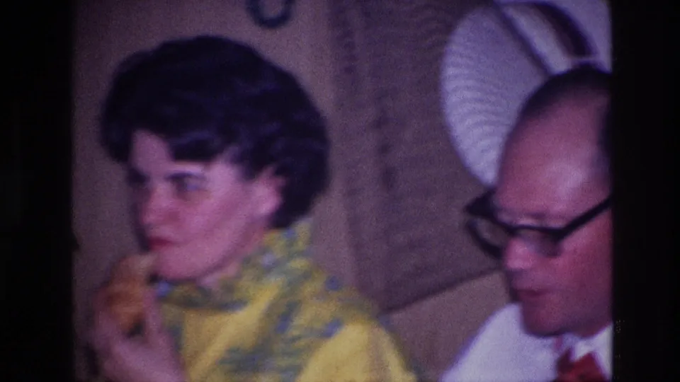 1967 Ottawa restaurant frame showing the woman eating as the man sits beside her in the booth.