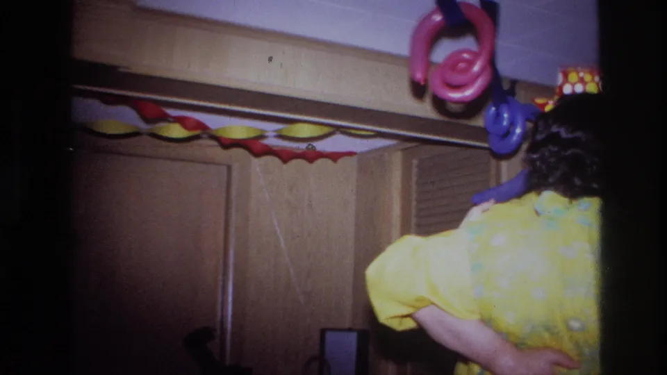 Ottawa 1967 party frame with a yellow-clad adult below pink and blue balloon shapes and red-yellow garlands.