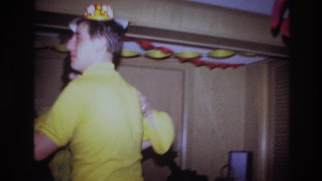 Young man in a yellow turtleneck turns while dancing with a woman.