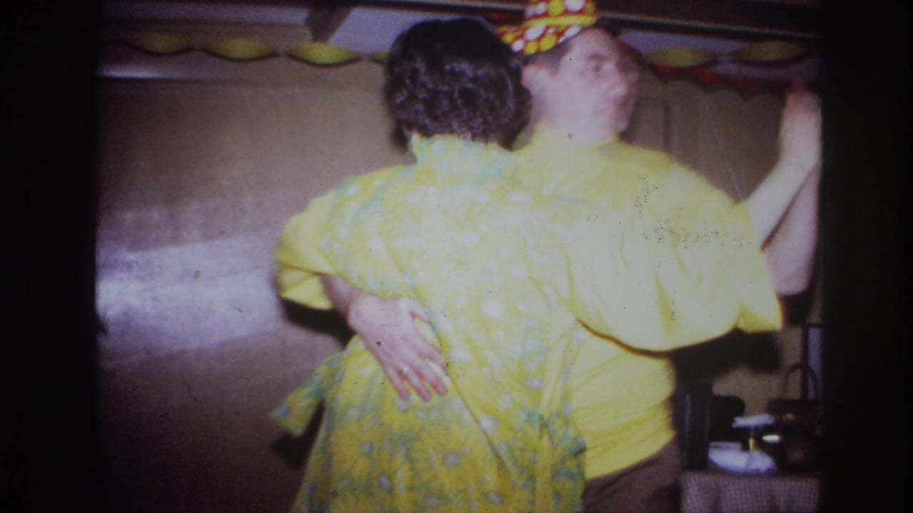 The dancing couple turns away from the camera in a warm indoor Ottawa party scene from the 1967 8mm home movie.