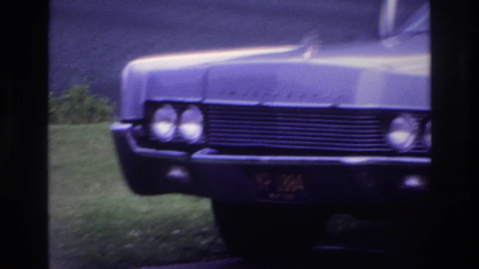 1967 Ottawa frame showing the sedan's broad grille, paired headlights, chrome trim, and visible front plate through the window.