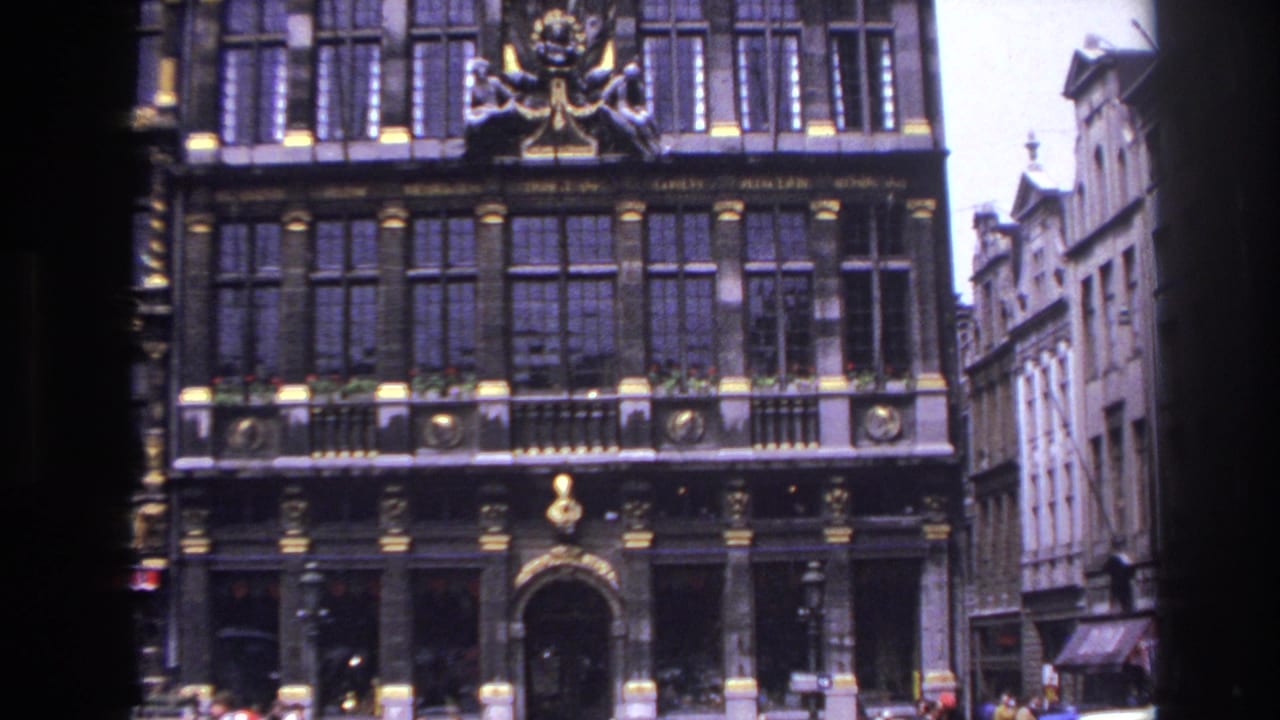 Tall decorated facade with an arched doorway and people near the lower edge.