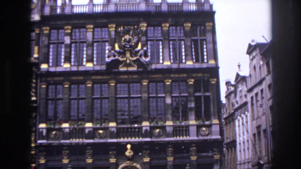1967 Paris architectural view focused on upper windows, balcony railings, flower boxes, and decorative gold trim.