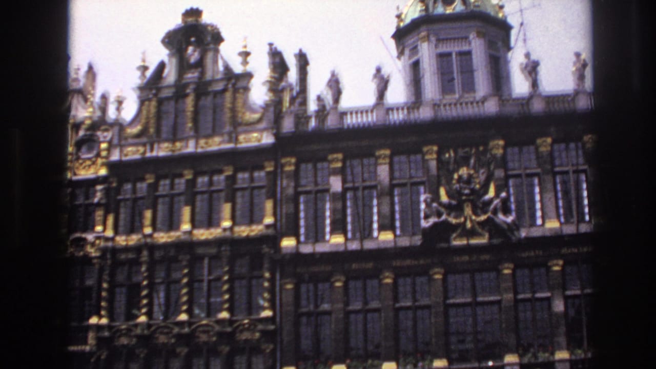 Closer view of a decorated facade with statues, gilded panels, and a central ornamental feature.