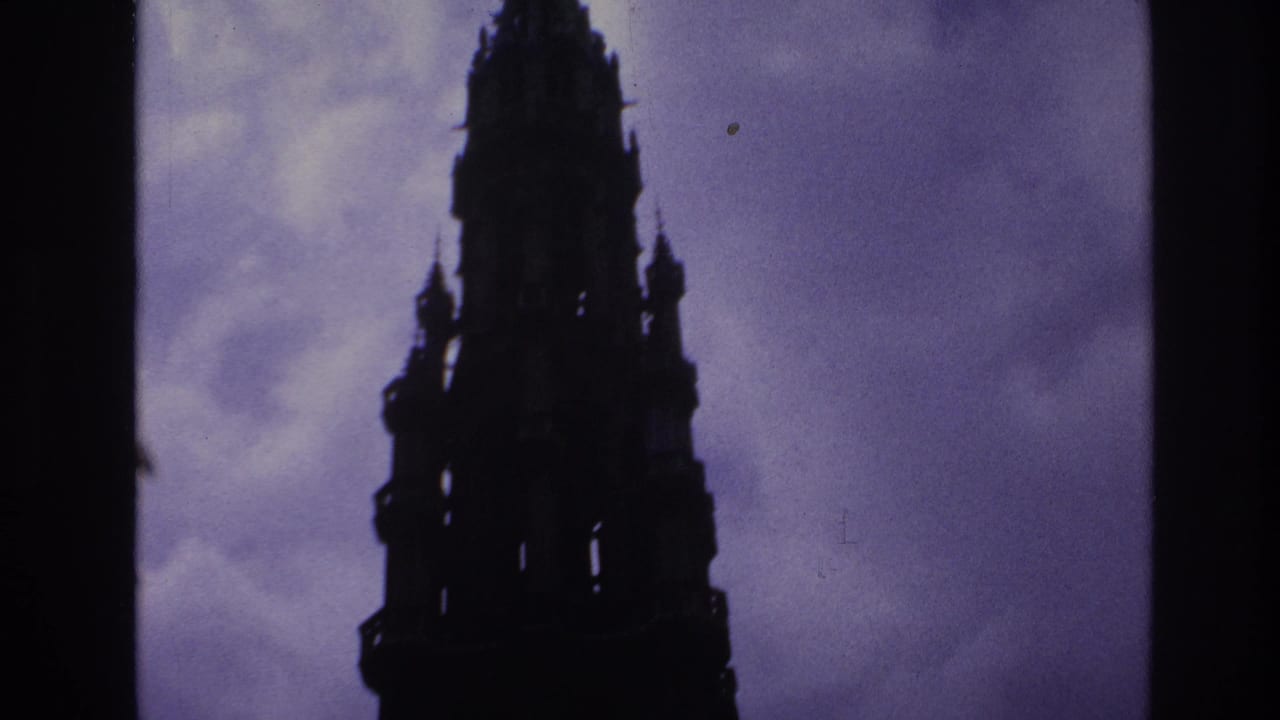 Tall Gothic tower silhouette framed against a purple sky.