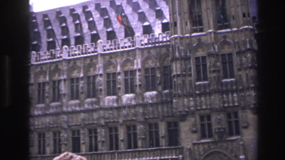 1967 Paris frame showing a historic Gothic-style building facade, flag, and central dark window mullion.
