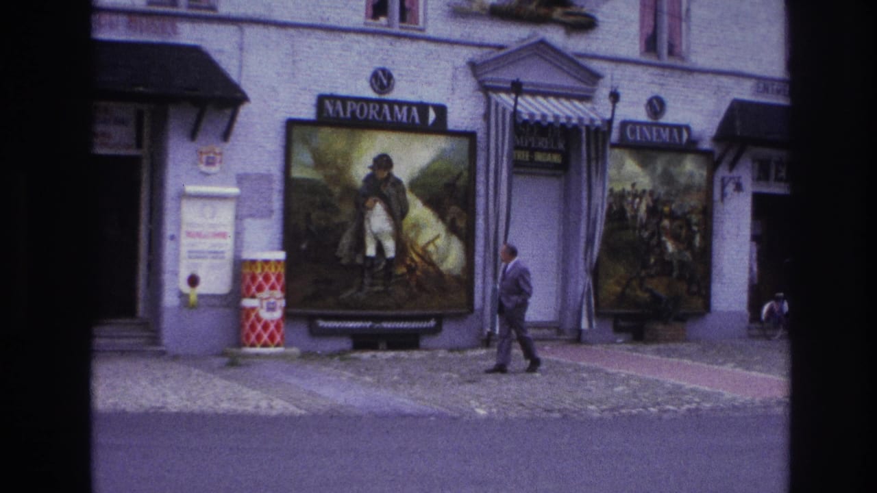 1967 Paris street view with a suited man passing Napoleonic-themed Naporama posters and a cinema sign.