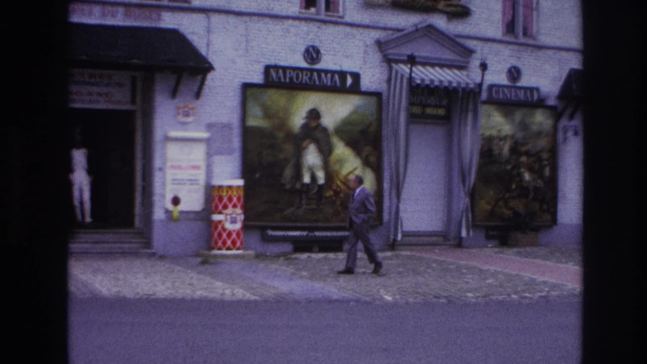 Paris, 1967, with a man walking past an open exhibit doorway, Naporama poster, and cinema signage.