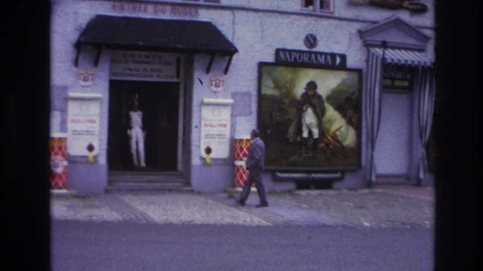 Late-1960s Paris exterior with a suited pedestrian, Naporama signage, and museum or cinema frontage.