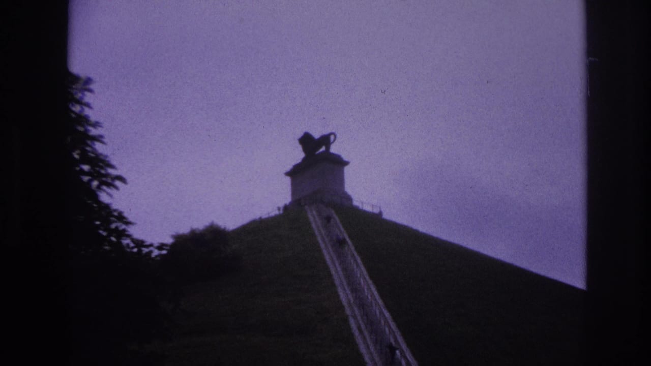 Steep hillside stairs lead upward to a stone structure topped by a dark lion statue.